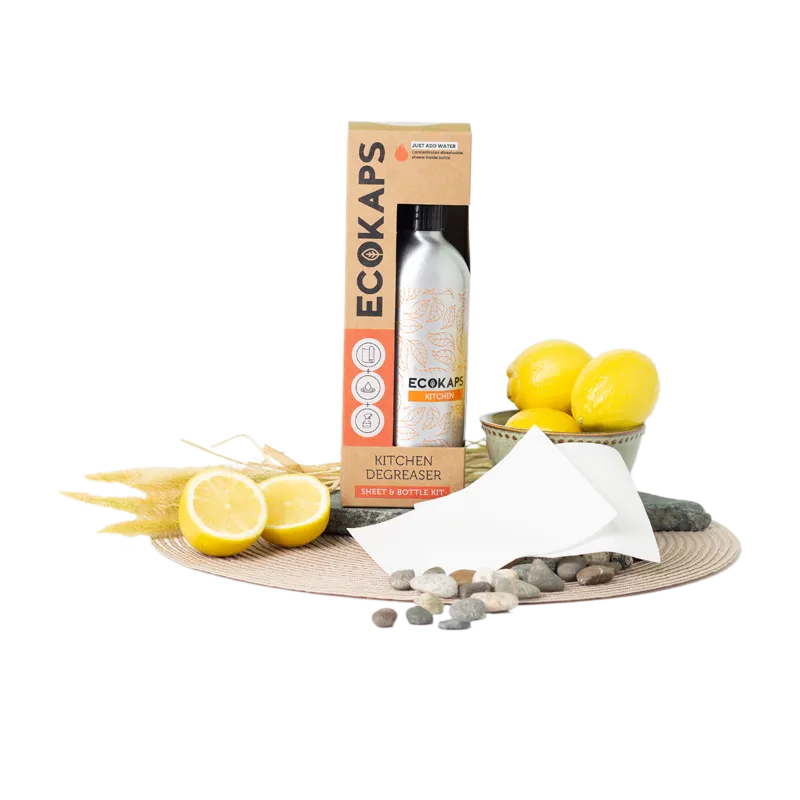 ECOKAPS kitchen degreaser sheet & bottle kit with lemons and stones on a white background